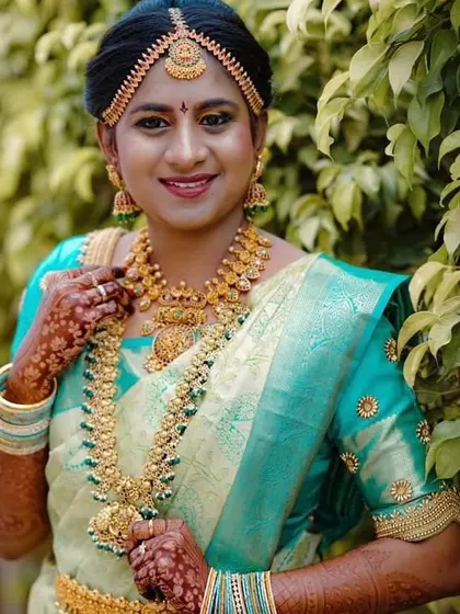 This bride looks gorgeous in a mint green silk saree. I designed a simple yet elegant matching blouse with gold butti work and a detailed border on the sleeves.