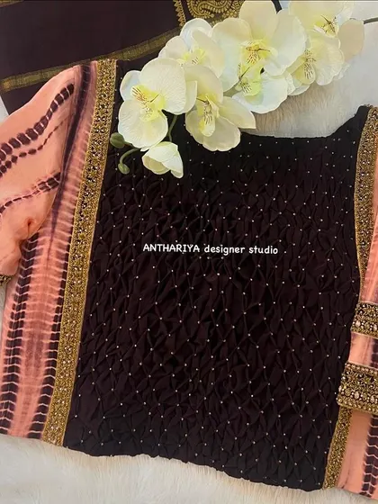 A unique blouse made with a combination of wine-colored fabric and peach tie-dye sleeves.