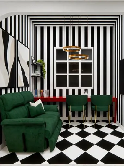 Here, I explored a bold, maximalist concept for a cozy corner. The black-and-white striped walls and checkered floor create a dramatic, graphic backdrop for a vibrant green sofa, showing how to have fun with pattern and color.