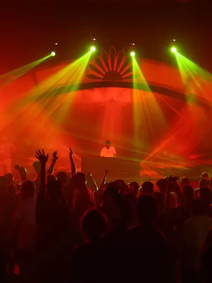 The stage is ablaze with red and yellow lights, creating a high-impact visual that matches the intensity of the music.