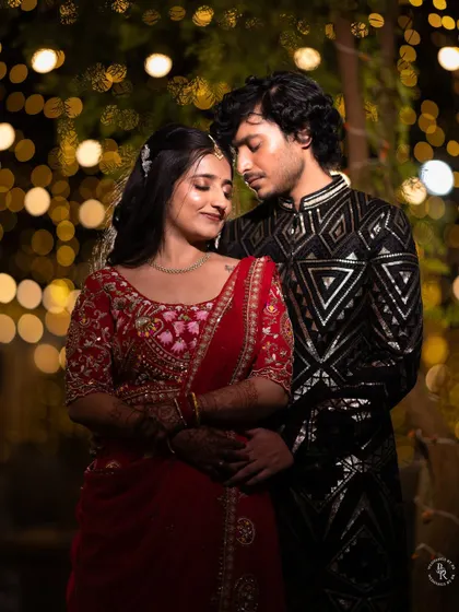 A romantic couple portrait under a canopy of fairy lights, their expressions full of love and happiness.