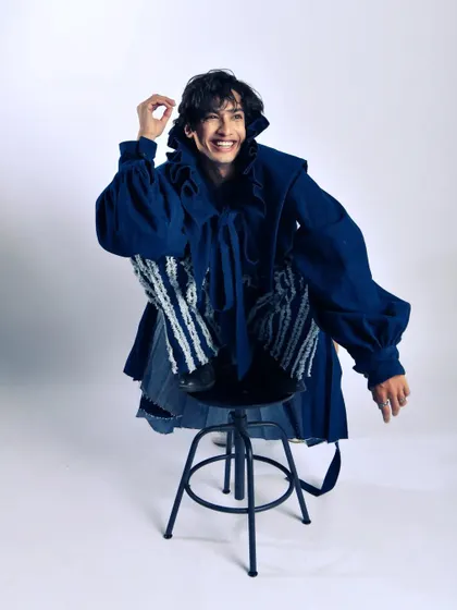 Even in high fashion, there's room for joy. This candid laugh breaks the tension and adds a human element to the avant-garde styling.