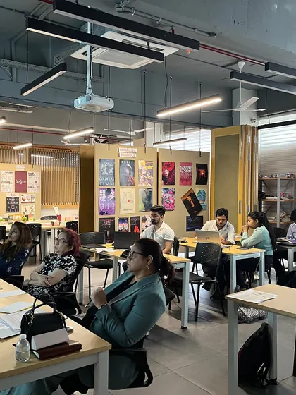 A wider view of the jury session at the JS Institute of Design. The room is filled with creative energy as students present their final projects, showcasing their skills in illustration and design.