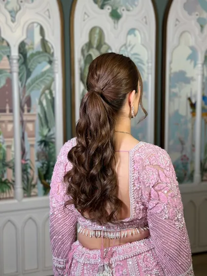 A back view of the soft curls ponytail, perfect for a reception or cocktail party.