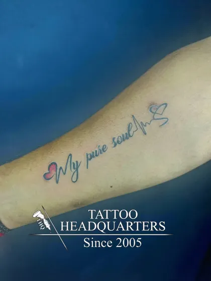 A "My pure soul" script tattoo with hearts and a heartbeat line, symbolizing a life lived with purity and love.
