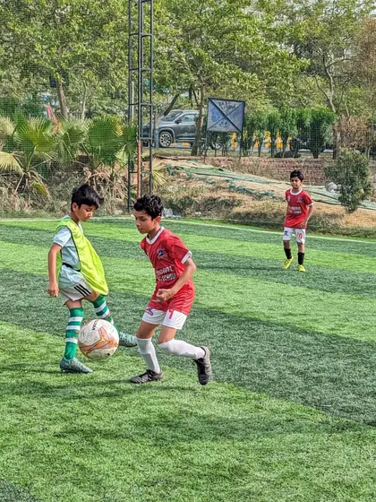 A one on one duel for the ball, a common sight in our competitive youth football matches.