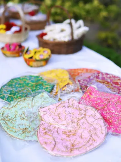 A table displaying colorful potli bags as Mehendi favors for guests, a thoughtful and traditional detail.