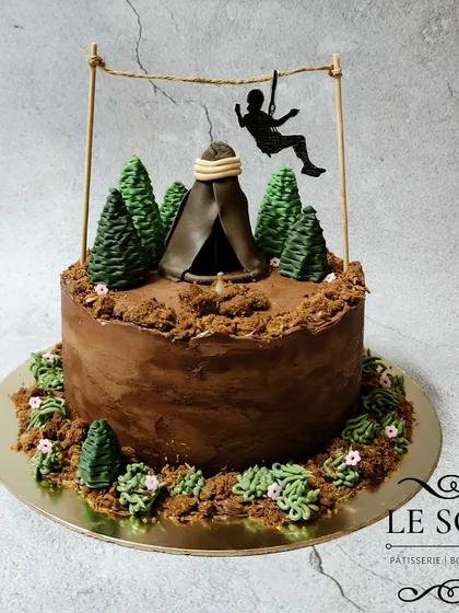 This camping-themed cake is perfect for an adventurer. The 1 kg Chocolate Truffle cake has a ganache finish, edible dirt, buttercream trees, and a fondant tent with a zip-liner.