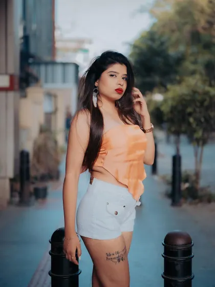 A full-body shot of a model in a casual outfit. The urban street setting and her confident pose make this a great example of everyday street style.