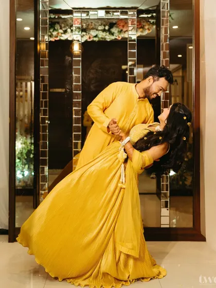 A joyful dip! This playful and romantic pose during the haldi photoshoot captures the fun-loving spirit of the couple, a perfect memory of their pre-wedding excitement.