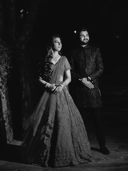 A classic, full-length portrait in black and white. The dramatic lighting and timeless feel of monochrome make this a powerful and elegant shot.