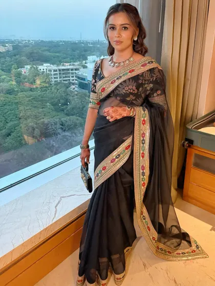 A full-length view of this elegant reception look. The dewy makeup and soft waves create a look that is both sophisticated and ready for a night of celebration.