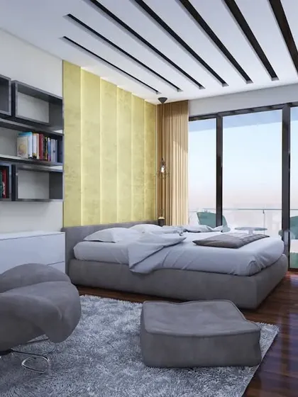 The bedroom includes a comfortable lounge chair and ottoman, creating a perfect reading corner with a view.