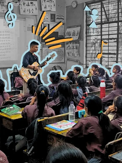 A fellow plays the guitar, with lyrics projected on the screen behind him. This combination of audio and visual aids helps reinforce learning and keeps students engaged throughout the session.