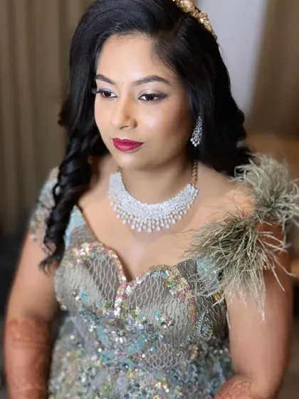 A side profile showing the dramatic eye makeup and the elegant hairstyle with soft curls.