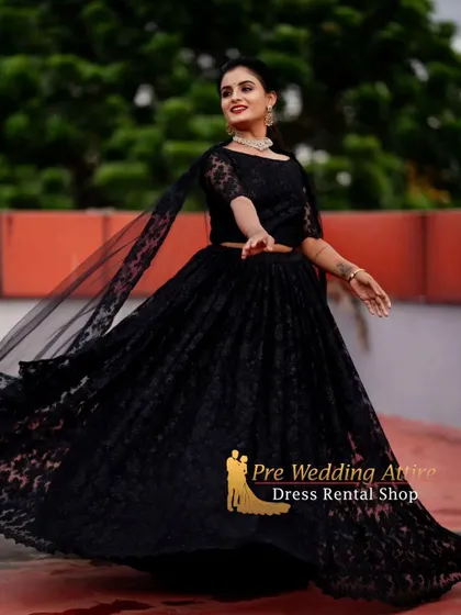 A twirling shot of the black lace lehenga, showing the movement of the skirt and the sheer cape.