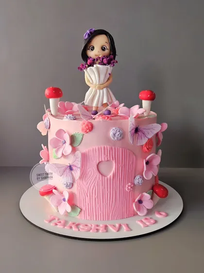For lil Takshvi's birthday, we created this unique design of a girl in a bouquet frock. The cake itself is a delicious chocolate strawberry flavor, and the figurine on top is completely handmade by me.