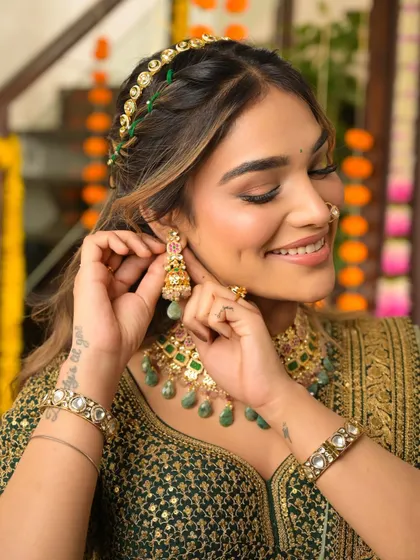 A happy, candid moment. The makeup looks fresh and radiant, highlighting her beautiful smile.