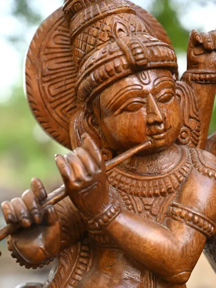 A close-up of the 20-inch Radha Krishna statue, focusing on Krishna's serene face as he plays the flute. The detail captures a moment of pure divine music.