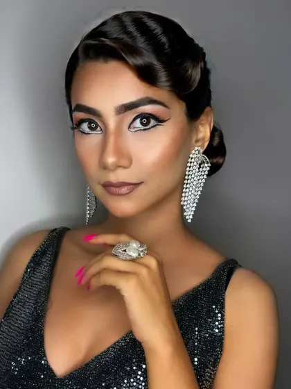 The full effect of this glamorous party look. The sleek hair, sparkling dress, and bold makeup come together to create an unforgettable, red-carpet-ready style.