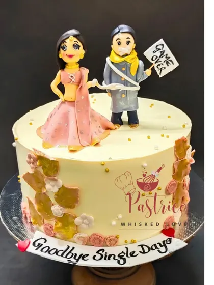 A fun "Goodbye Single Days" cake for a groom-to-be, with a humorous handmade topper showing the bride leading him to the finish line.