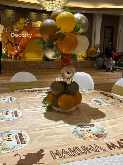 A guest table ready for the party, with a themed tablecloth and a balloon centerpiece, showing the attention to detail.