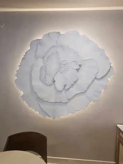 The 3D floral installation seen from a different angle in the dining room. The ambient lighting completely changes its mood, making it a dynamic piece of art day or night.