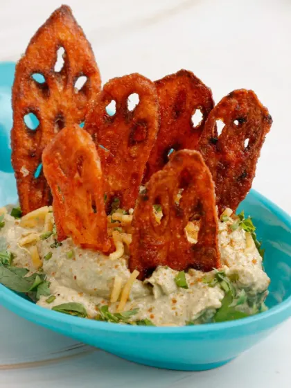 A close-up of our crowd-pleasing Peri Peri Crispy Lotus Stem Chaat. The vibrant colours of the dish and the unique shape of the lotus root chips make it as visually appealing as it is delicious.