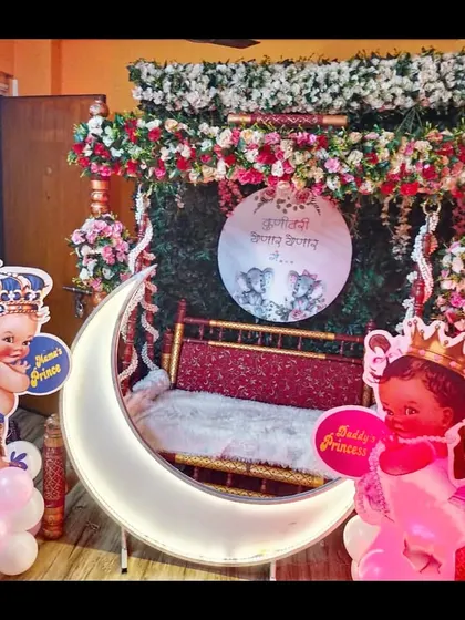 Another angle of the home baby shower decor, showing the beautiful floral arrangement on the swing and the 'Kunitari Yenar Yenar Ga' sign.