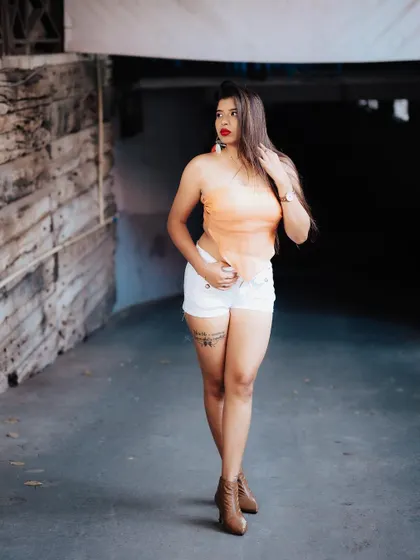A full-length shot of a model in a casual outfit, walking through an underpass. The leading lines and her confident stride create a dynamic and stylish image.