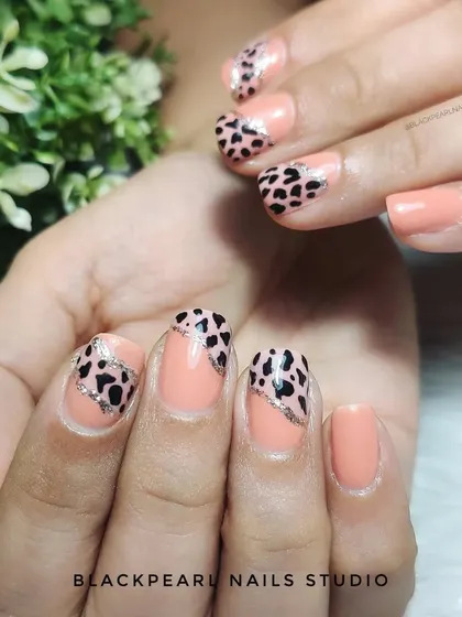 A stylish safari on your nails, this design pairs a nude polish with an animal print accent. It's a chic and trendy way to incorporate a wild pattern into your look.