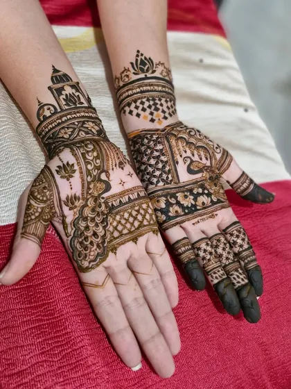 A lovely combination of traditional motifs, with a peacock on one hand and a lotus with temple architecture on the other.