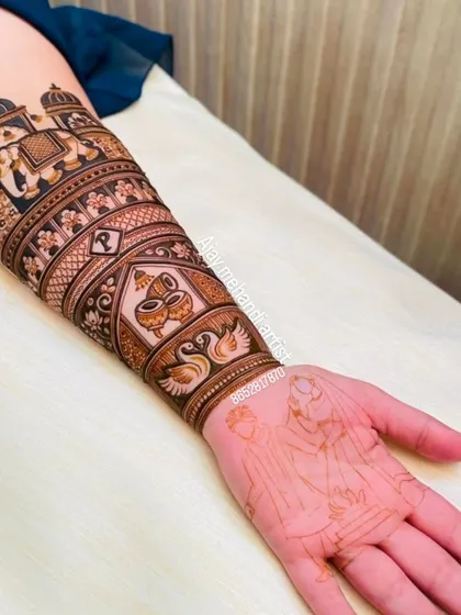 The nearly complete arm design, showing the elephant procession on the forearm and the outline of a couple's portrait on the palm.