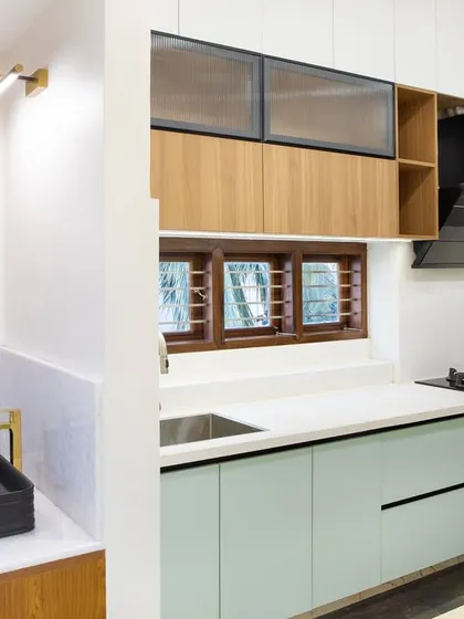 This shot captures the beautiful color palette of the sage green kitchen. The clean lines and ample storage provide both function and style, proving that practical can be pretty.
