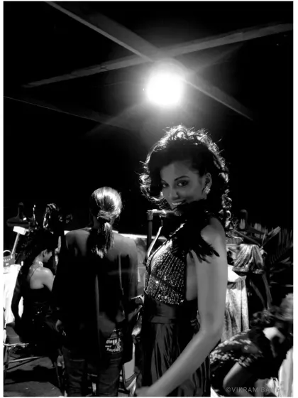 A behind the scenes shot of the spotlight rebel, Mugdha Godse, during a shoot featuring a stunning Falguni Shane Peacock creation.