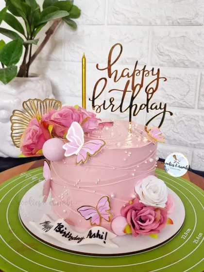 A rosey affair. This pretty pink cake is decorated with a string-pull texture, fresh roses, and delicate butterflies for a romantic and feminine birthday.