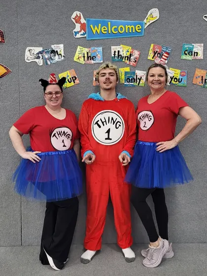 Thing 1 and Thing 2 have arrived! Our coaches pose in front of a Dr. Seuss-themed backdrop, showcasing the level of detail we put into our themed events.