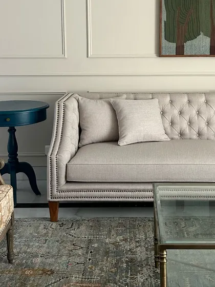 A classic tufted sofa waiting for its final styling. The details, like the nailhead trim, are what make a piece special.