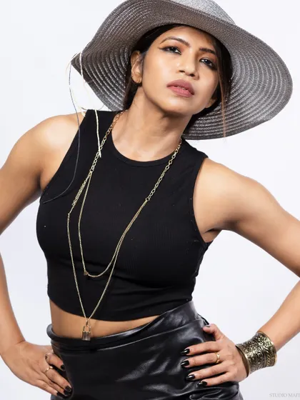 A close-up of the model with the hat, focusing on her confident expression.