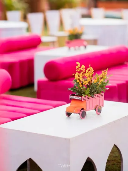 It's the small, quirky details that make an event unique. This miniature truck centerpiece, filled with flowers, added a playful and memorable touch to the Mehendi seating area.
