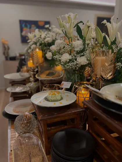 The right ambiance can turn a meal into magic. This is a glimpse of one of my evening setups, where candlelight, fresh white lilies, and thoughtfully arranged dishes create a warm and sophisticated atmosphere for an intimate gathering.