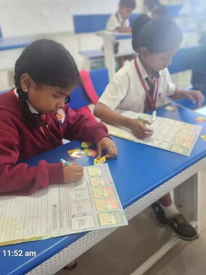 Two students collaborate on a worksheet, demonstrating the peer-to-peer learning and teamwork that our activity-based sessions encourage.