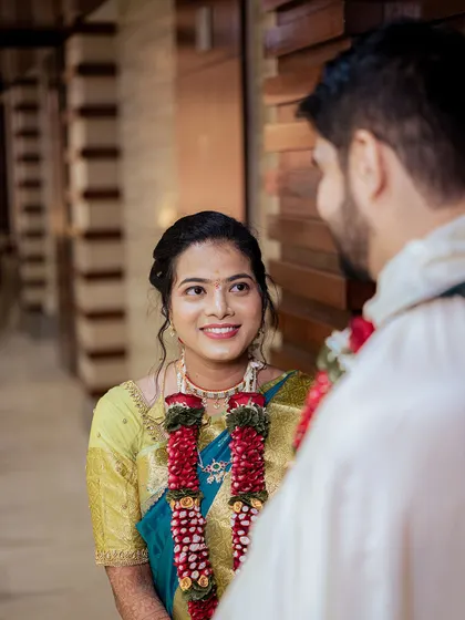 A beautiful shot capturing the bride's loving gaze towards her groom during their South Indian wedding ceremony.