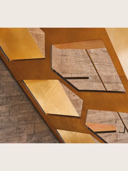 An abstract detail of a staircase, combining wood, brass, and concrete. This composition showcases the careful attention given to material junctions and textural variety in my projects.