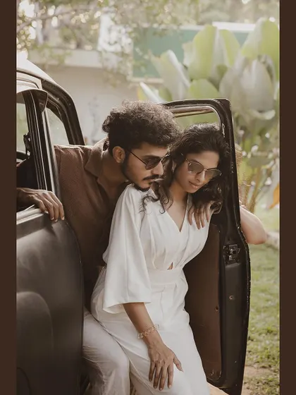 A cool and romantic pose with a couple in a vintage car.