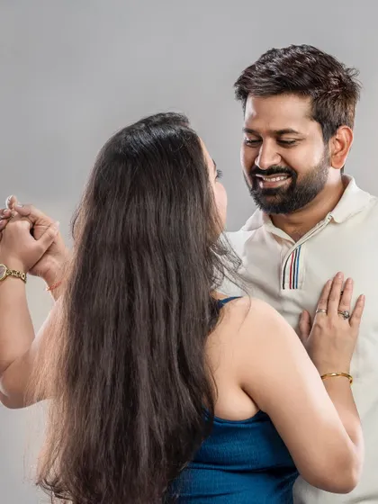 This photo captures the joy of a couple dancing together in the studio. It's a simple, happy moment that tells a story of their connection, perfect for celebrating a milestone.