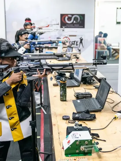 A shooter's perspective, aiming down the lane at the electronic target.