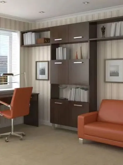 A traditional home office design with dark wood furniture and a comfortable sofa, creating a classic and formal workspace.