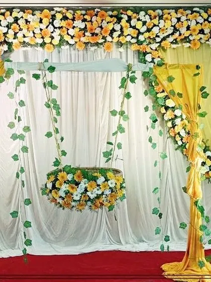This view shows the complete floral swing setup for a naming ceremony. The design is both traditional and beautiful, providing a perfect spot for the baby's first official ceremony.