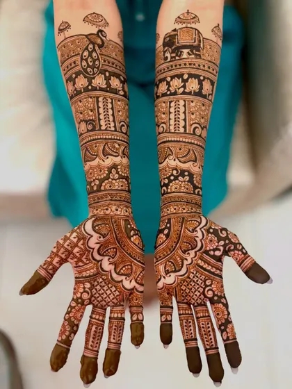 A stunning full-arm bridal design with traditional elephant, peacock, and lotus motifs.